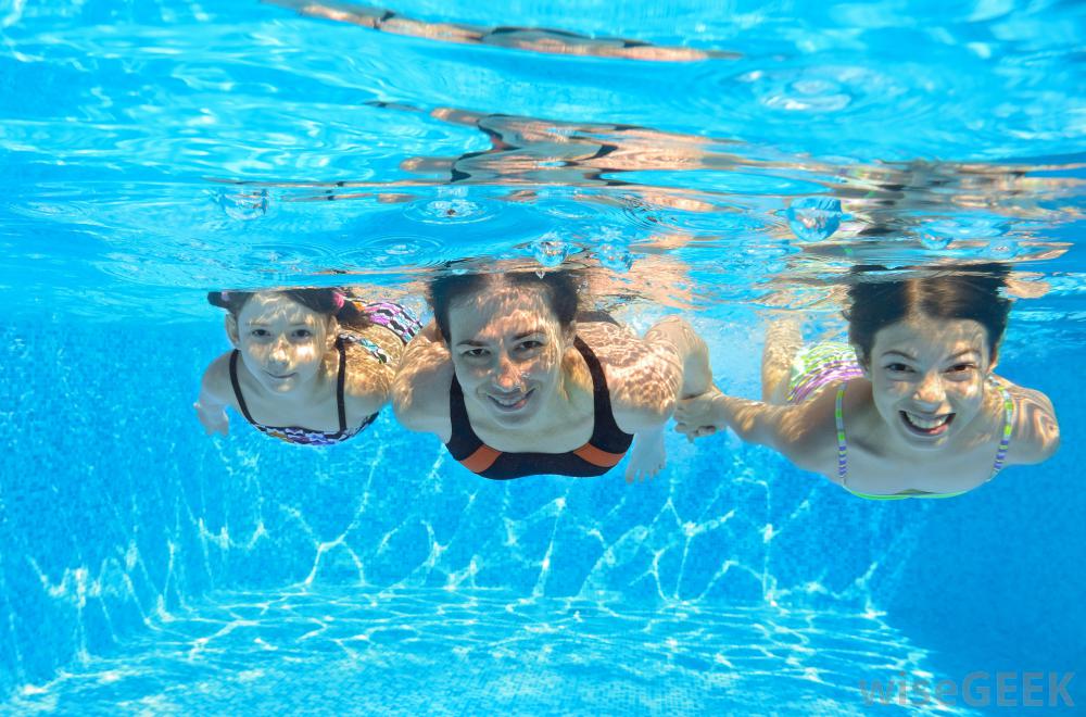 three-people-swimming-under-water
